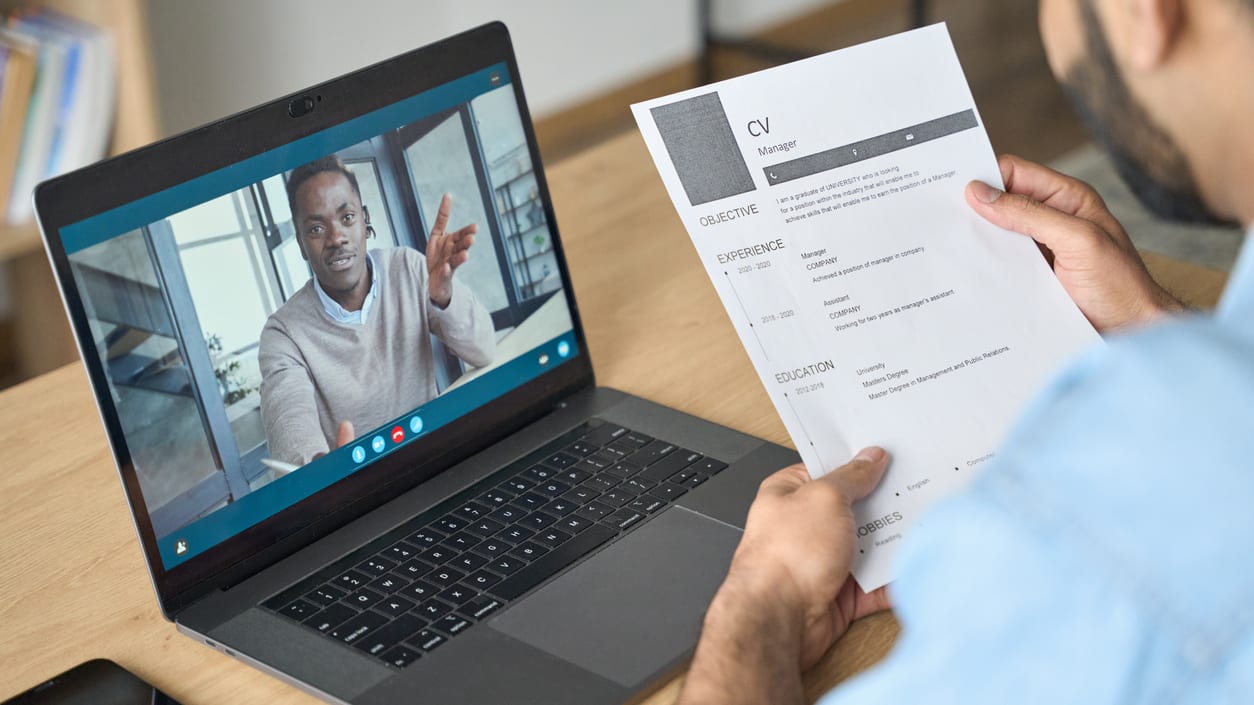 A man is using a laptop to make a video call.