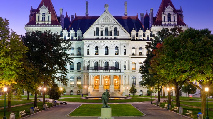 An ornate building lit up at dusk.