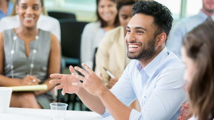 A group of people sitting in a conference room.