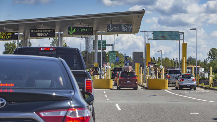 A group of cars at a toll booth.