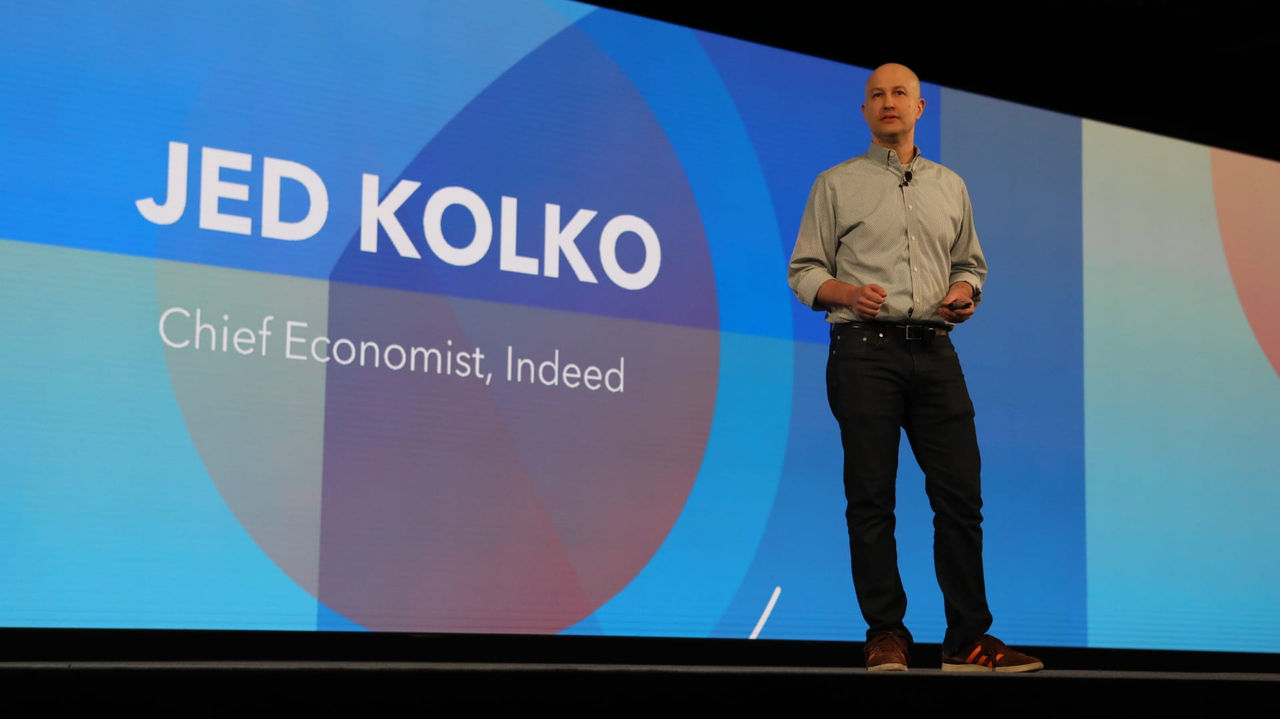 Jed kolko on stage at an event.