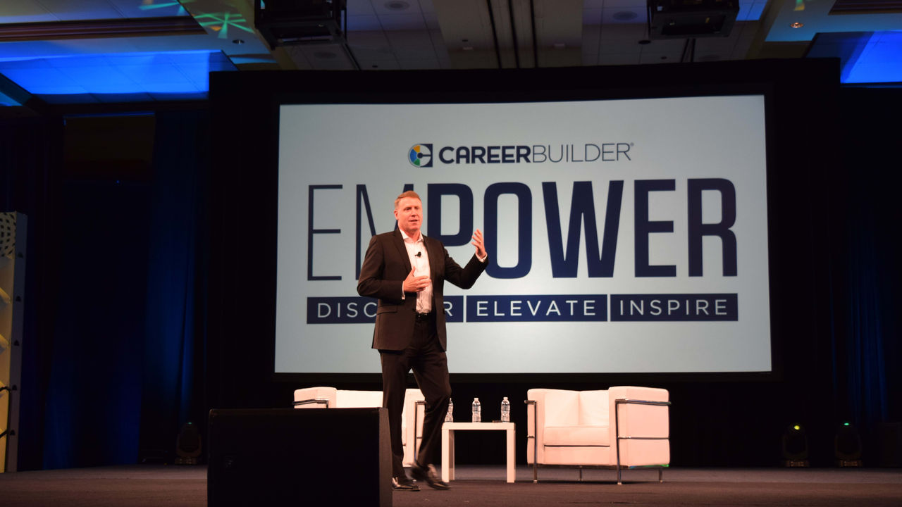 A man on stage at the enpower conference.