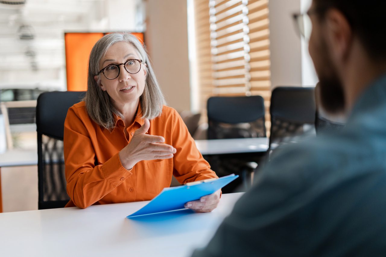 A job candidate and hiring manager engage in a job interview.