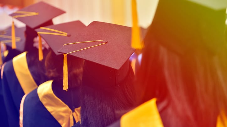 A group of graduates wearing graduation hats.