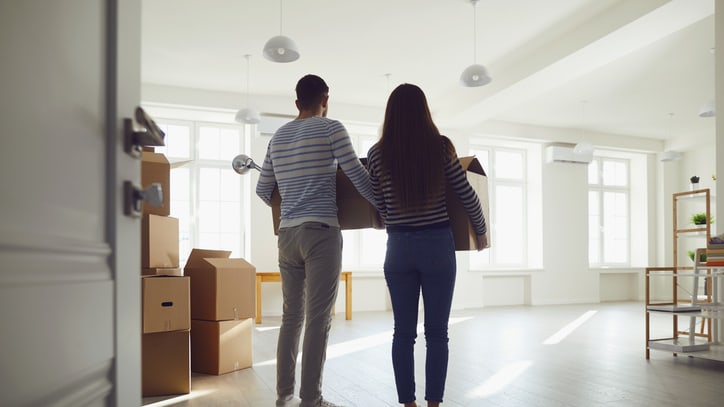 Young couple moving into a new home.