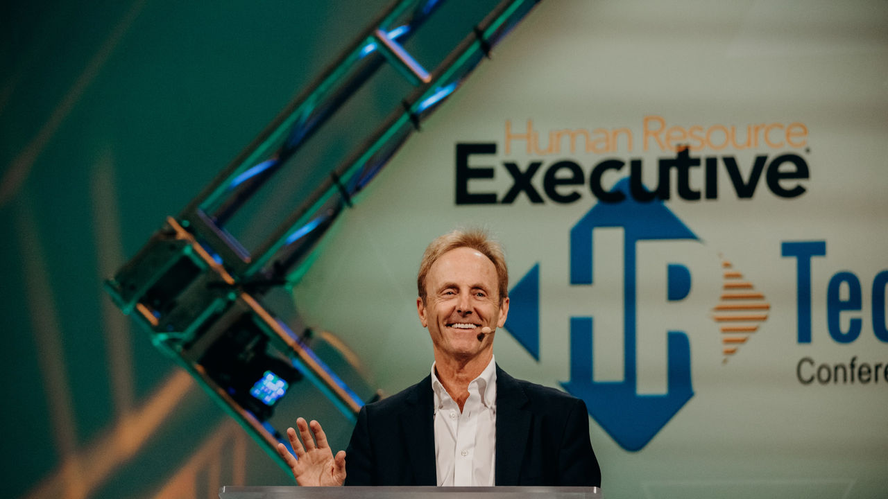 A man giving a speech at the hr tech conference.