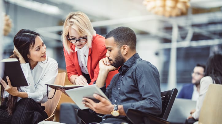 A group of business people working together in an office.