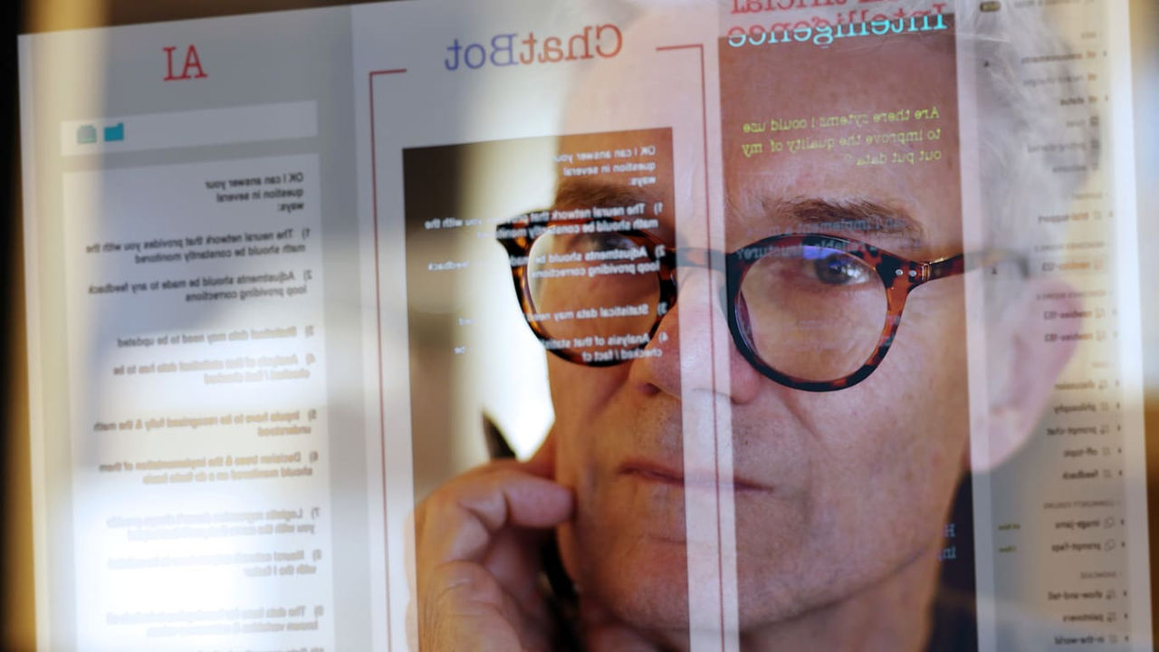 An image of a man wearing glasses on a computer screen.