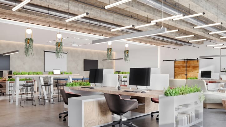 A modern office with lots of desks and chairs.