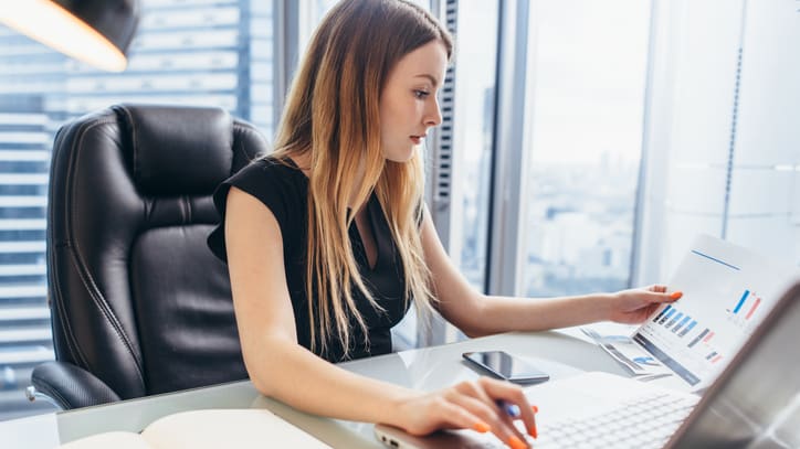 A business woman working on her laptop in an office.