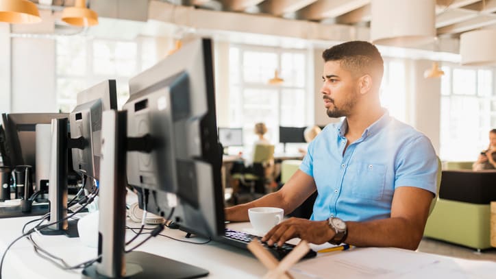 A man working on a computer in an office.