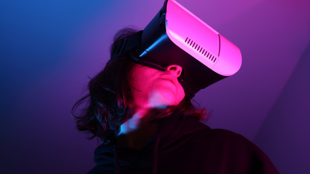 A person wearing a vr headset in a dark room.