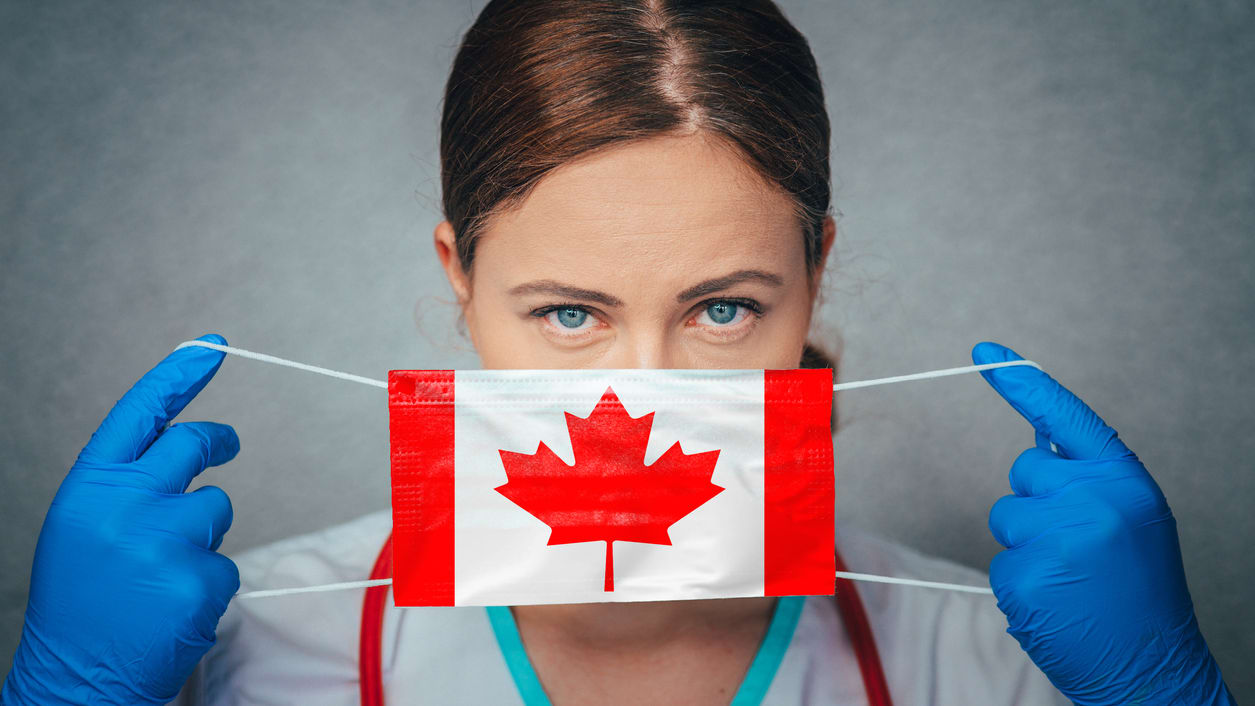 A female doctor wearing a canadian flag mask.