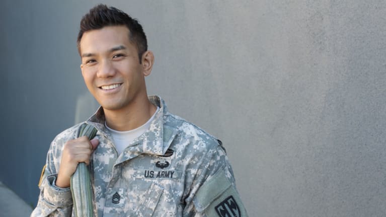 A smiling soldier in uniform.