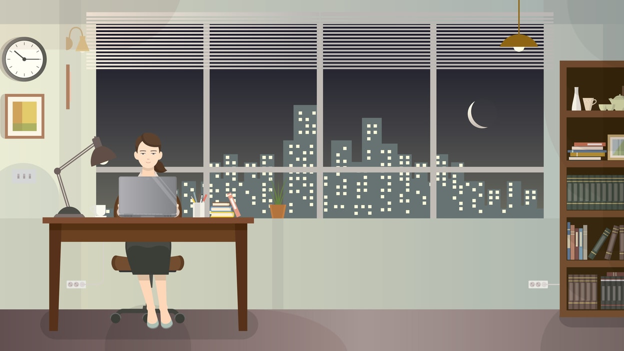 A woman working at her desk at night.