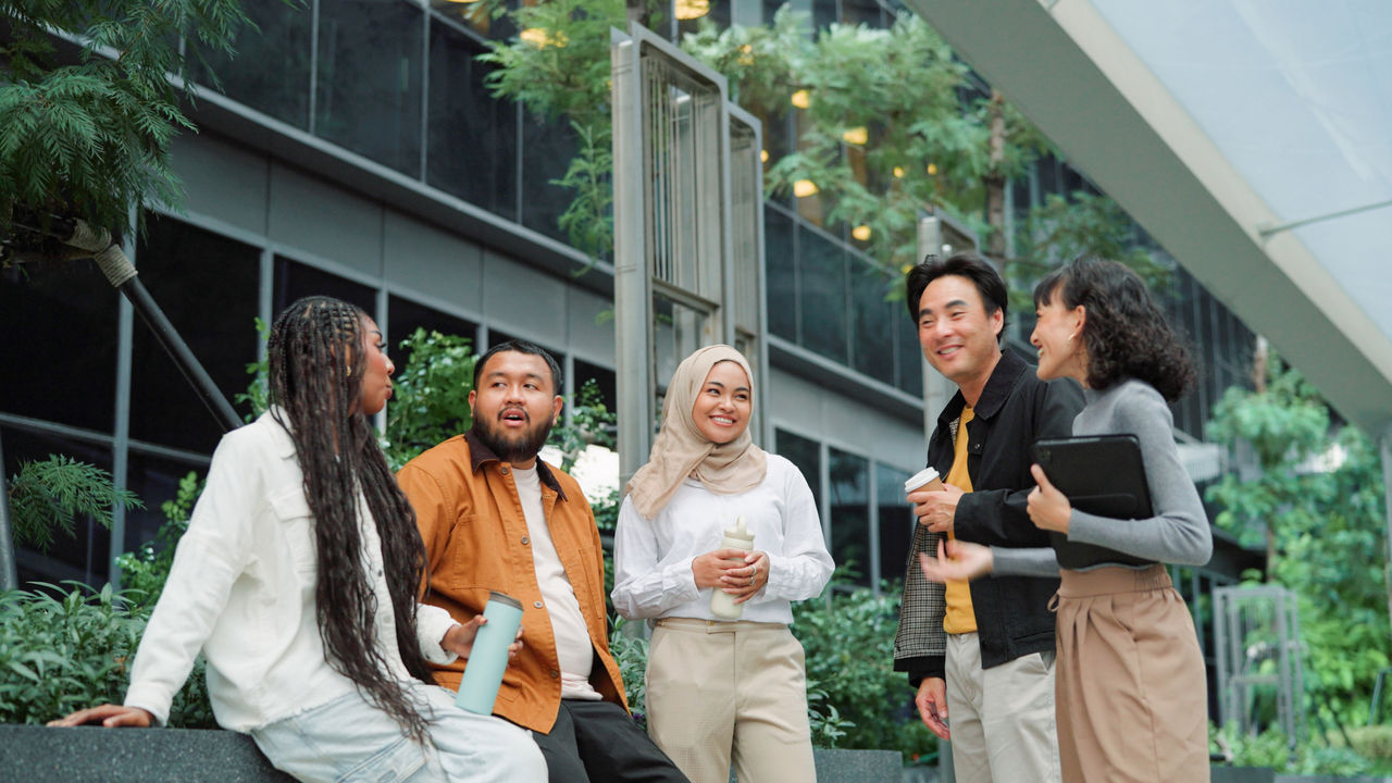 Asian business team taking a break and relaxing at green office