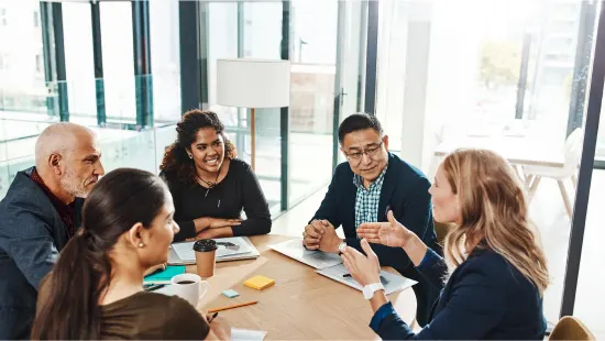 coworkers conversing around a table