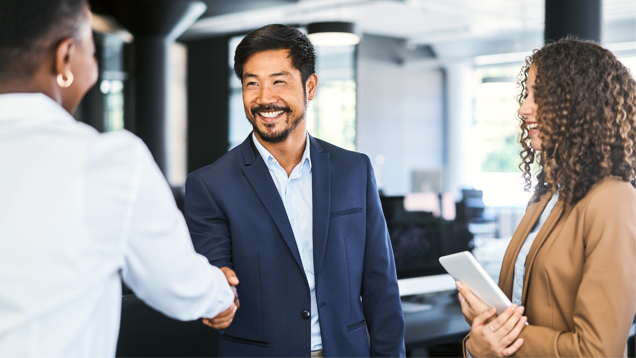R2_Chapters_Mocks Two professionals shake hands and smile