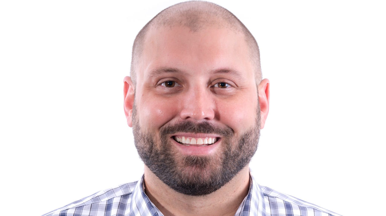 A man wearing a blue and white checkered shirt.