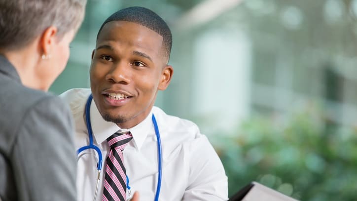 A male doctor talking to a female patient.