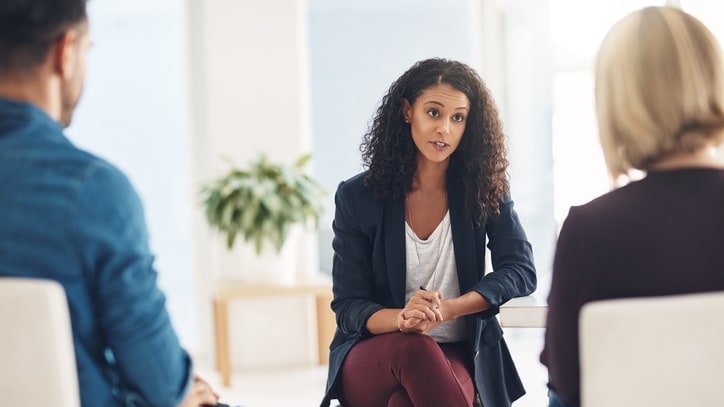 A group of people talking in a meeting room.