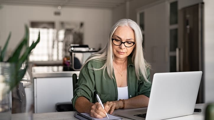 Senior woman working on laptop at home