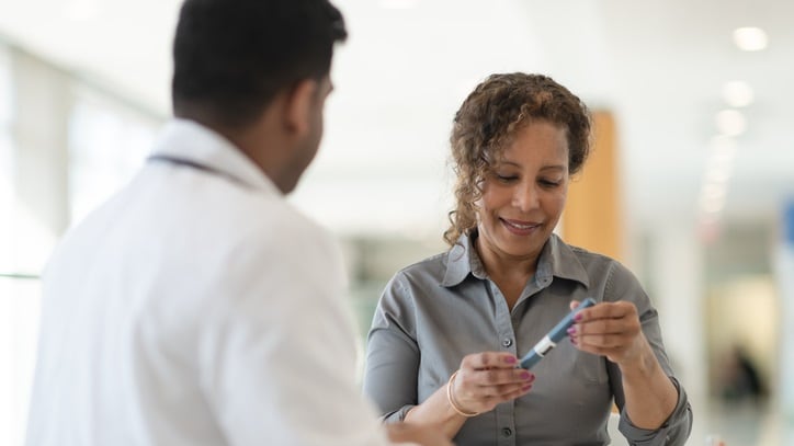 A woman is talking to a doctor about a blood test.