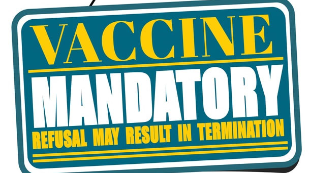A sign that says vaccine mandatory result in termination.