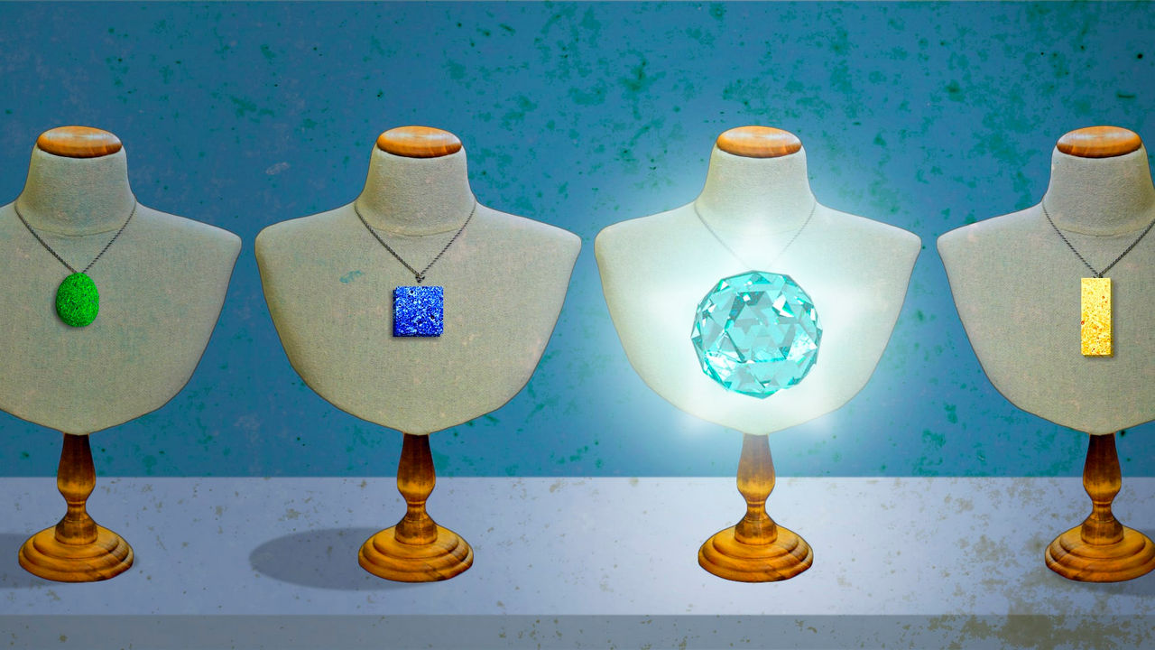 A group of mannequins with necklaces on them.