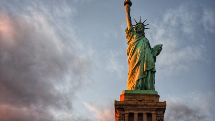 The statue of liberty at sunset.